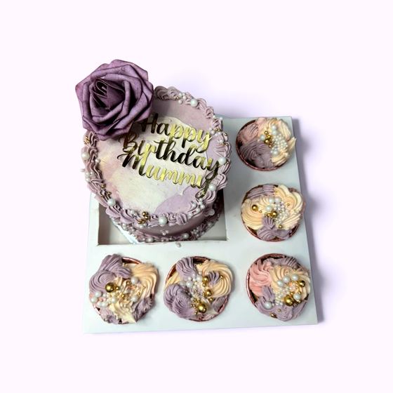 A bento cake and cupcake set finished with a sugar rose