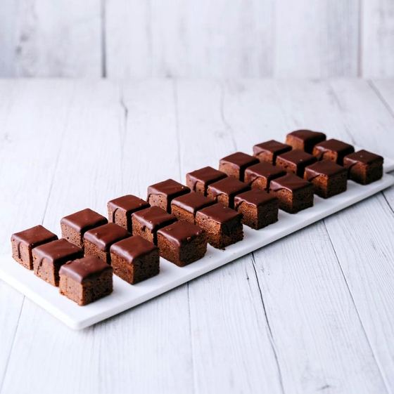 Chocolate glazed brownie bites on a serving platter