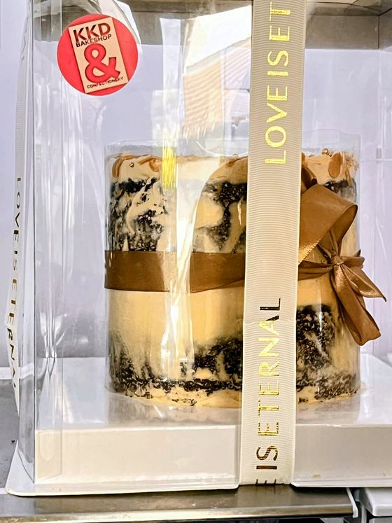 Signature salted caramel cake boxed with a caramel ribbon