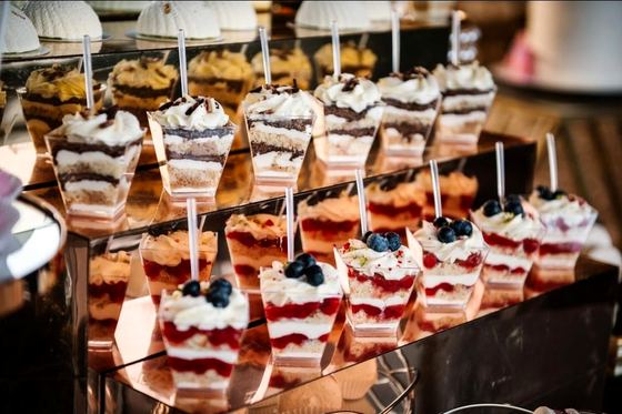 Layered individual dessert pots on a tiered stand